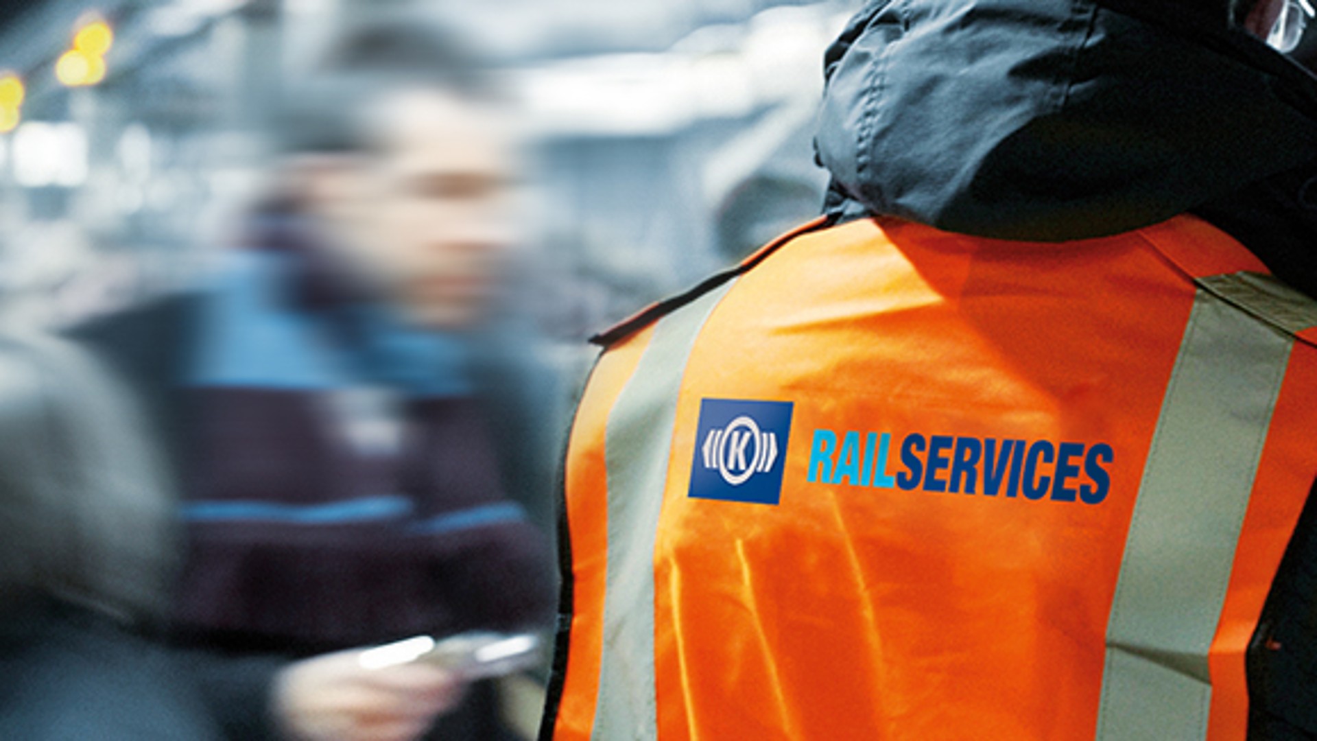 Rail services worker in high-visibility safety vest.