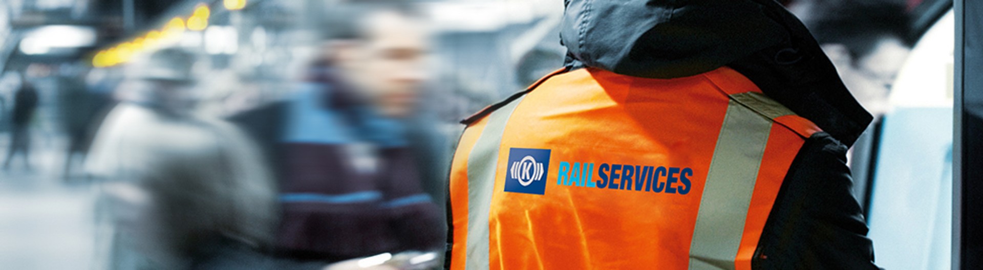 Rail services worker in high-visibility safety vest.
